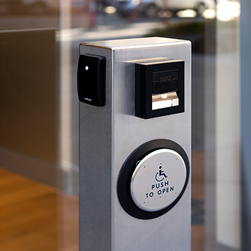 Pedestal PRO custom stainless steel cabinet with handicap push button actuator, Lenel® multi-tech reader, and 2N® intercom